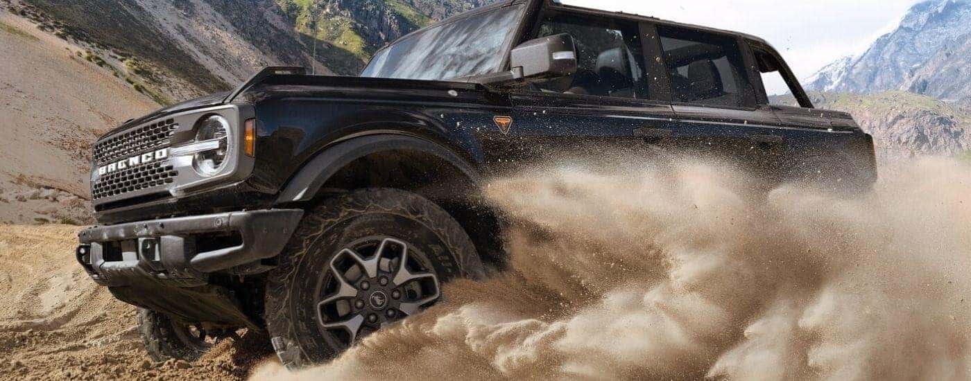 Black 2025 Ford Bronco Badlands off-roading through sand