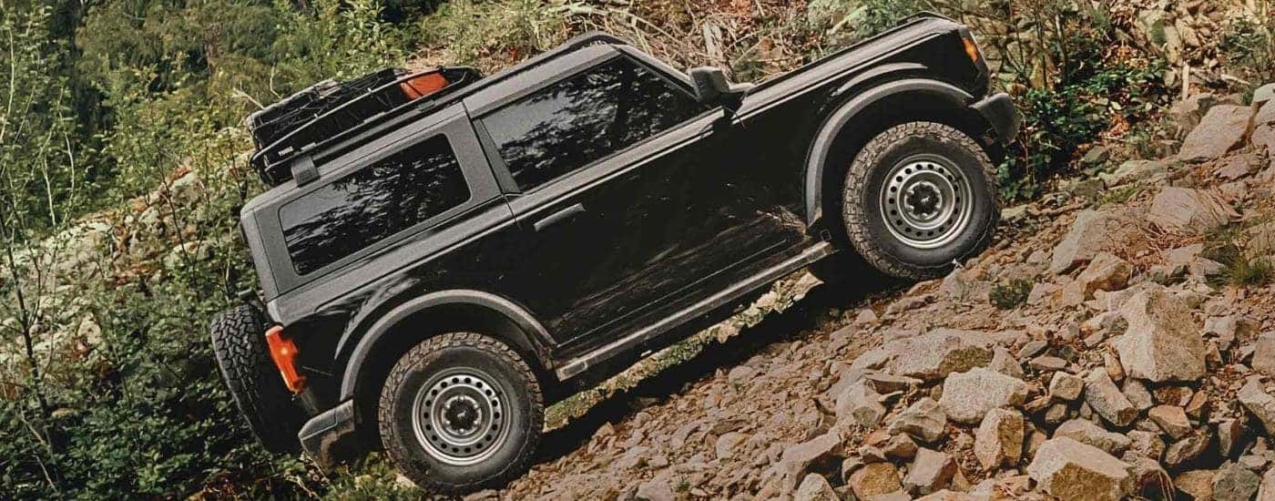 Off-roading black 2025 Ford Bronco on a steep hill