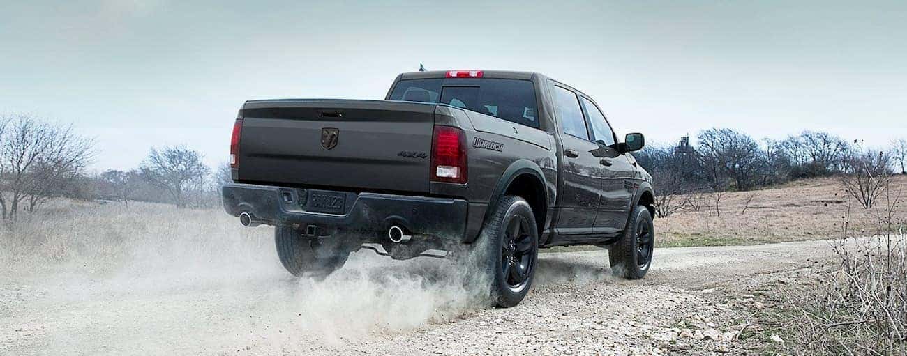 Black 2019 Ram 1500 Classic driving on a dusty trail