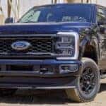 A black 2024 Ford F-250 parked off-road.