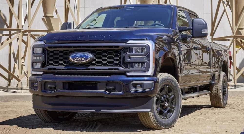 A black 2024 Ford F-250 parked off-road.
