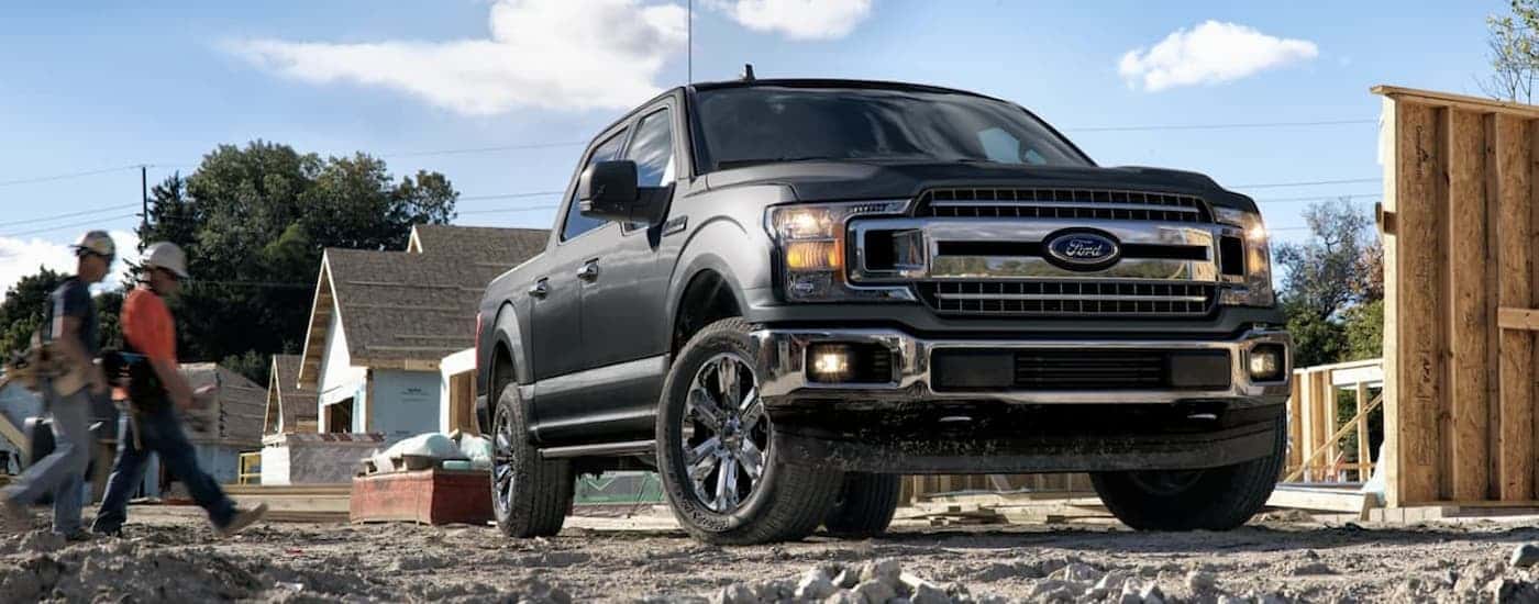 A gray 2020 Ford F-150 parked on a construction site.