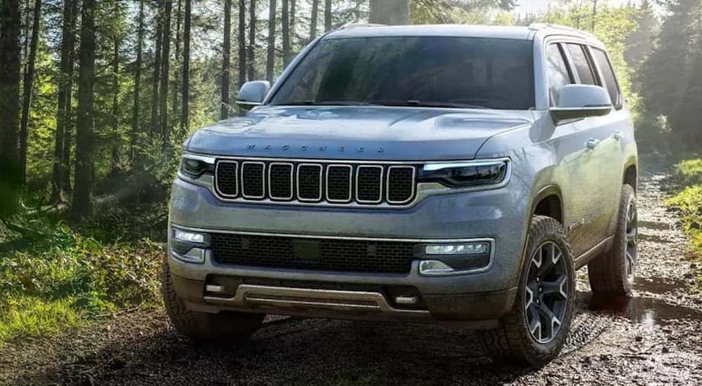 A white 2022 Jeep Grand Wagoneer from the front at an angle after leaving a dealer that has used cars for sale near Troy..