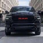 A black Ram 1500 limited Red Edition parked in a city
