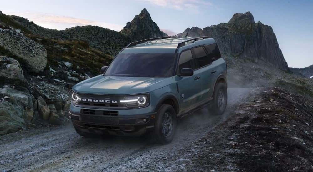 A blue 2024 Ford Bronco Sport Big Bend off-roading on a trail