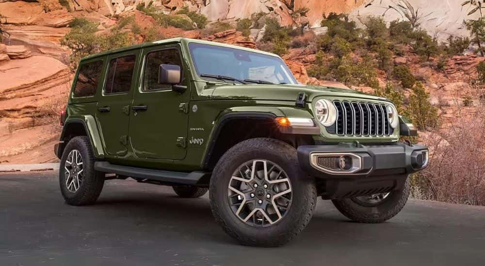 A green 2024 Jeep Wrangler Sahara Unlimited parked