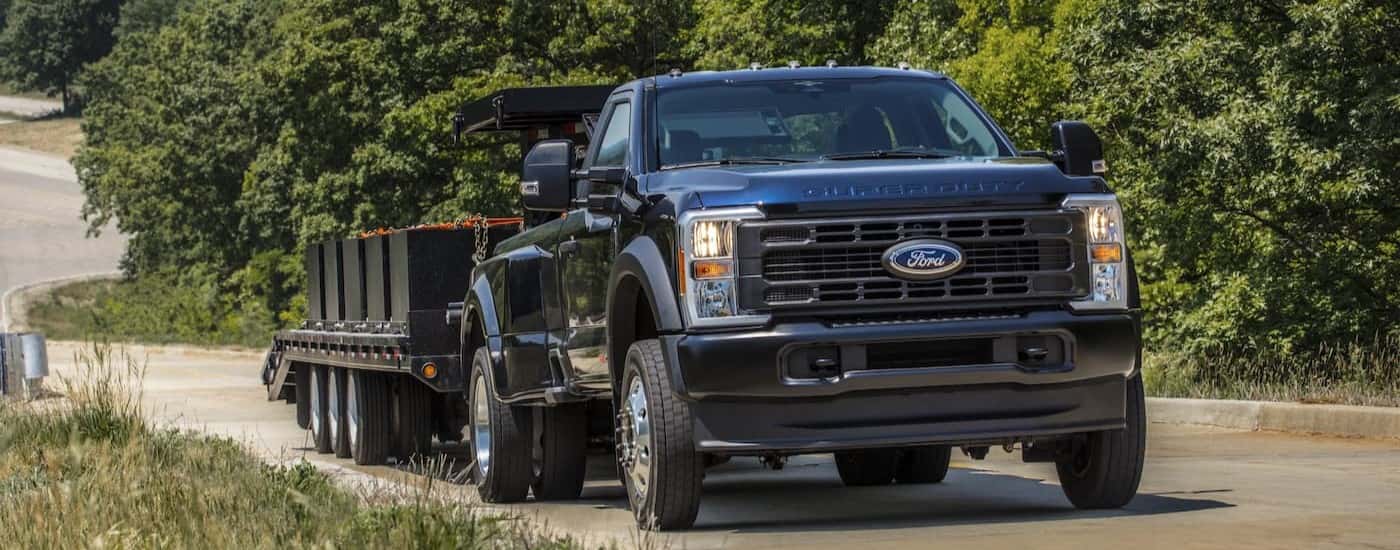 A black 2025 Ford F-250 towing a trailer.