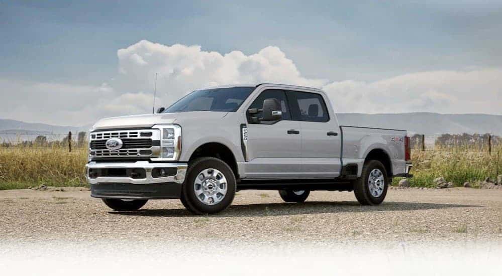 A white 2025 Ford F-250 parked near a field.