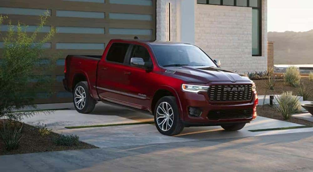 A red used 2025 Ram 1500 truck parked in a driveway for sale near Delmar