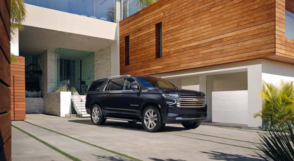 A grey 2022 Chevy Suburban from the side.