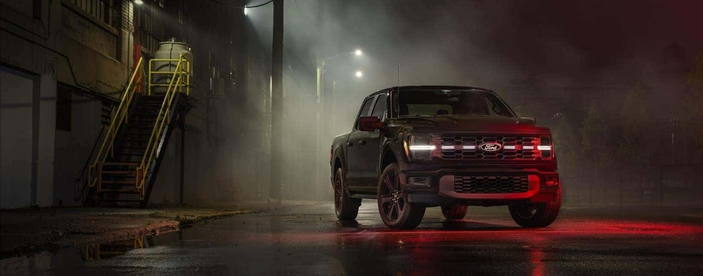 A black 2025 Ford F-150 Lobo parked at night.