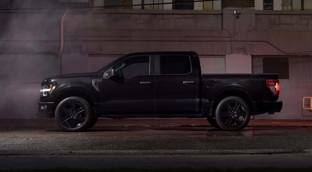 A black 2025 Ford F-150 Lobo parked at night.