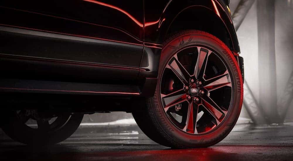 Close-up of a wheel on a black 2025 Ford F-150 Lobo.