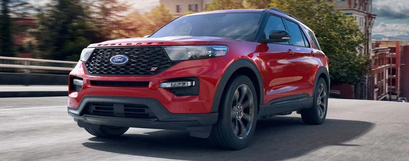 Red 2022 Ford Explorer ST driving on a city street