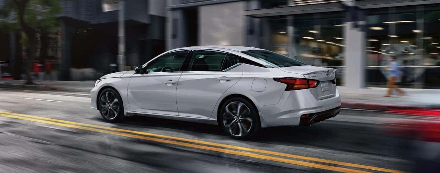 White 2024 Nissan Altima SR driving through a city