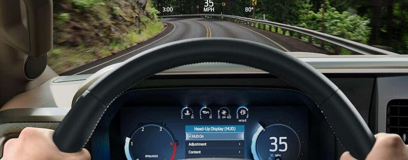 Person driving a 2025 Ford F-350 on a winding road