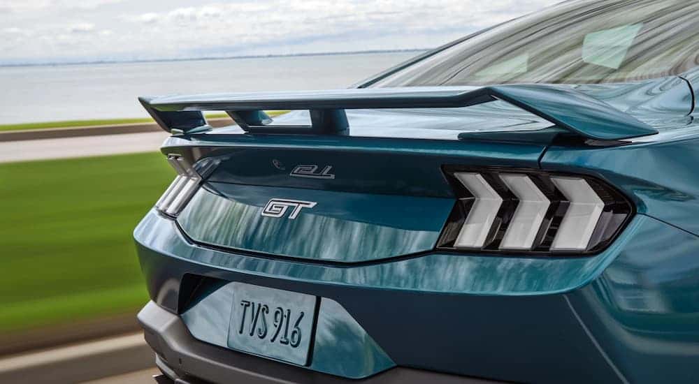 Rear taillights and spoiler on a blue 2026 Ford Mustang