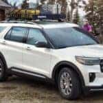 A white 2025 Ford Explorer near Schenectady parked near a log cabin.