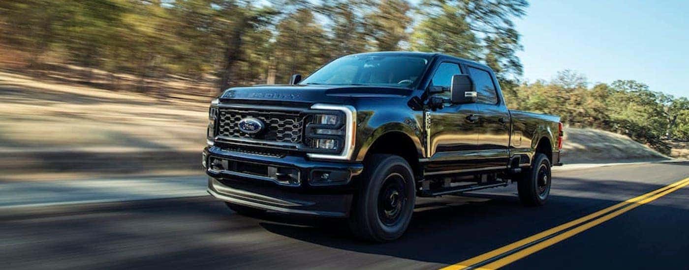 A black 2023 Ford F-250 from the front at an angle.