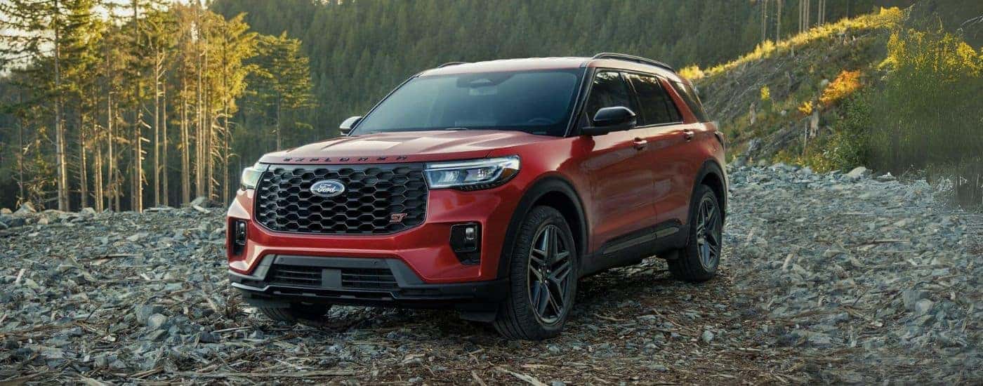 A red 2025 Ford Explorer ST parked off-road