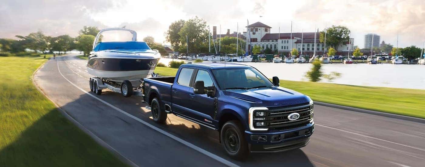 A blue 2025 Ford F-350 towing a boat