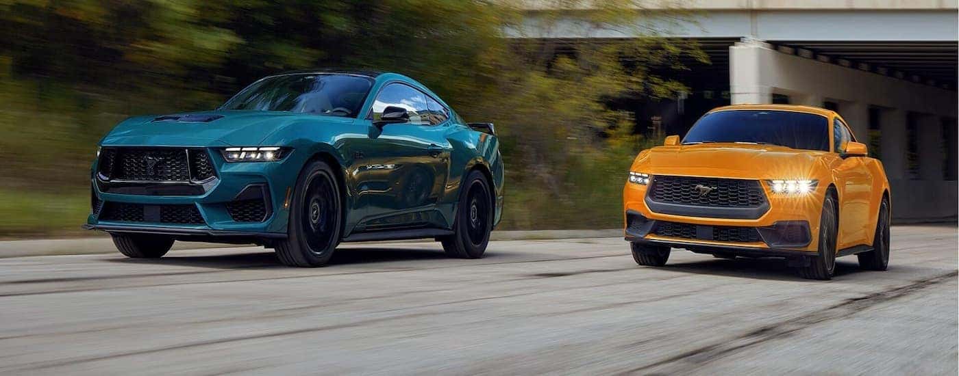 Two 2025 Ford Mustangs in all new Orange Fury Metallic Tri-coat and Adriatic Blue Metallic.