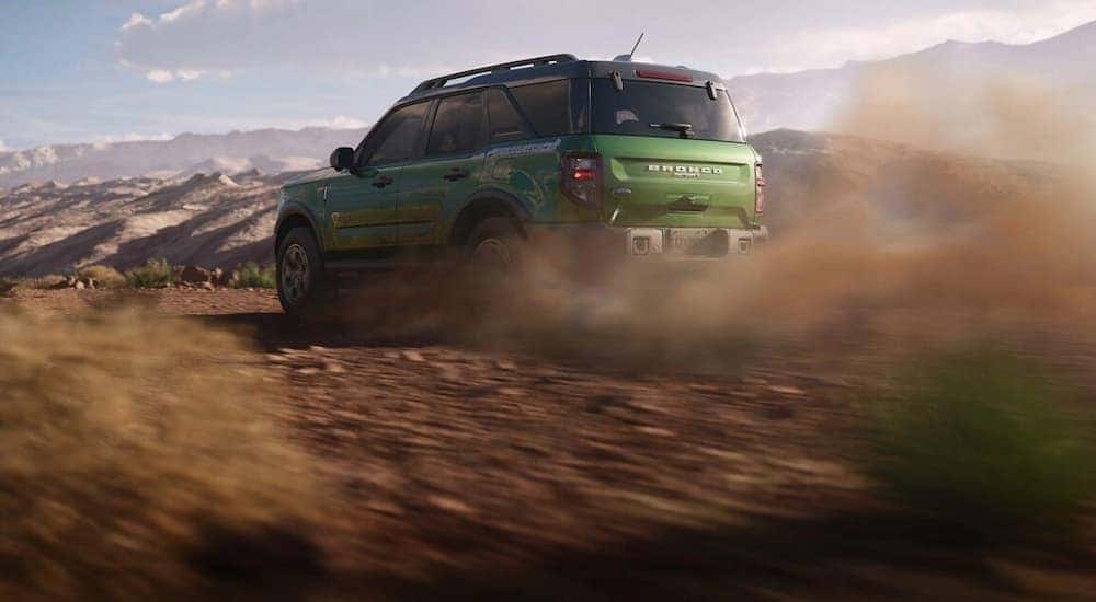 A green 2025 Ford Bronco Sport off-roading on dirt