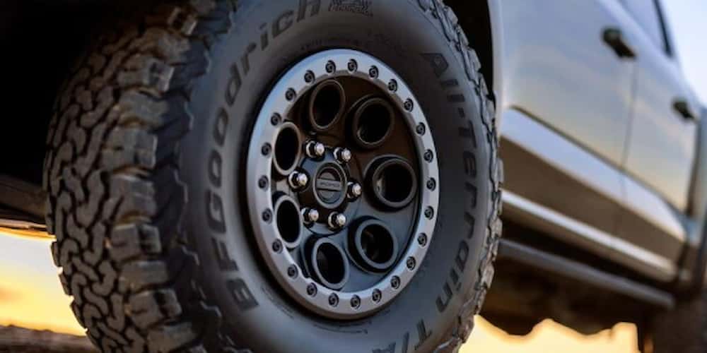 Wheel and tire of a 2025 Ford F-150 Raptor.