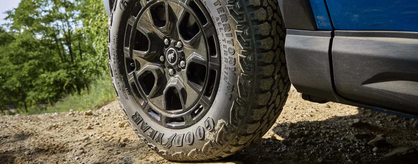 Tire and rim on a blue 2025 Ford Bronco Sport parked off-road