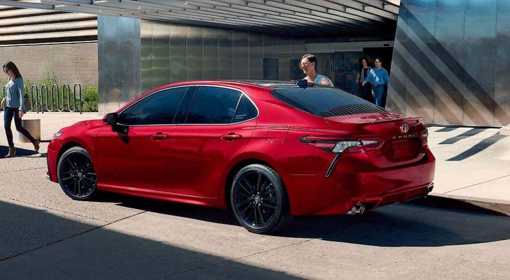 Red 2021 Toyota Camry with a family piling in