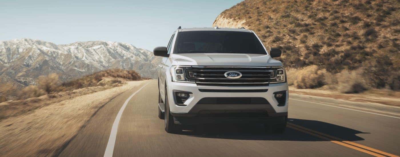White 2022 Ford Expidion driving to a used car dealer in Albany