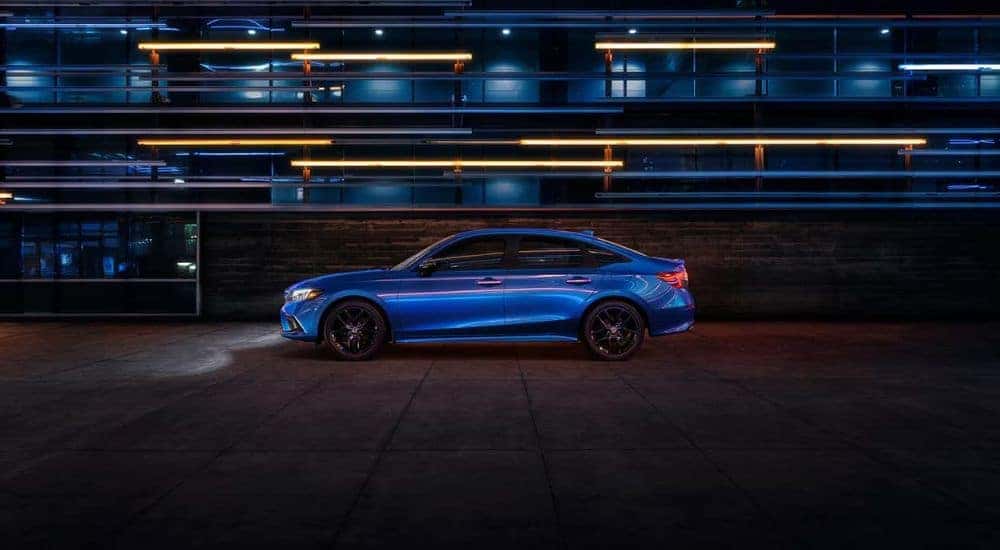 Blue 2022 Honda Civic driving to a used car dealer near Albany