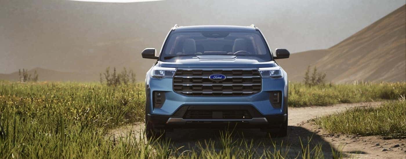 Blue 2025 Ford Explorer parked off-road from the front