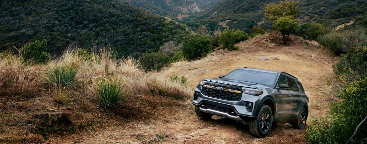 Silver 2026 Ford Explorer Tremor driving up a dusty trail