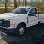 White 2026 Ford F-350 driving down a dirt road