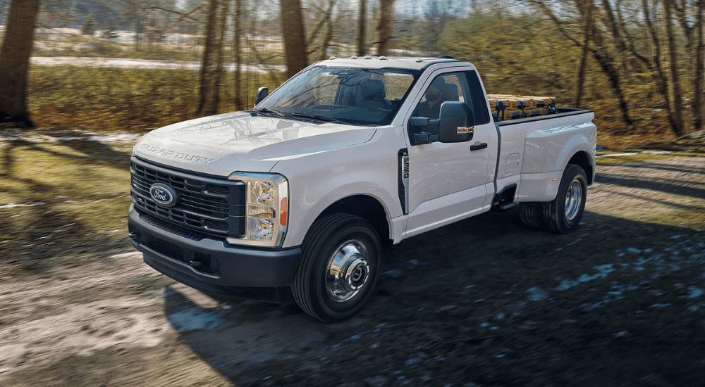 White 2026 Ford F-350 driving down a dirt road