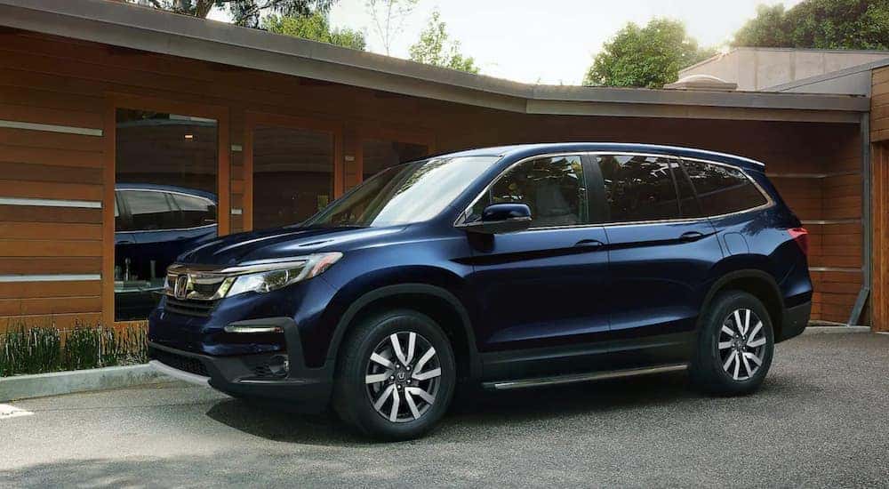 A blue 2021 Honda Pilot from the side.