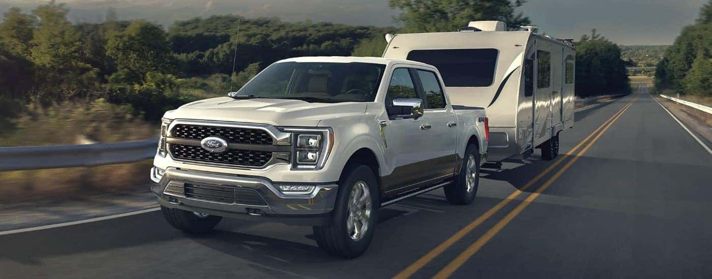 White 2022 Ford F-150 towing a camper