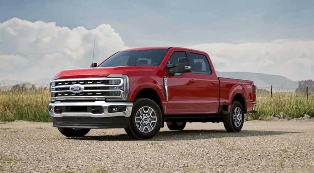 A red 2025 Ford F-150 Lariat parked off-road.