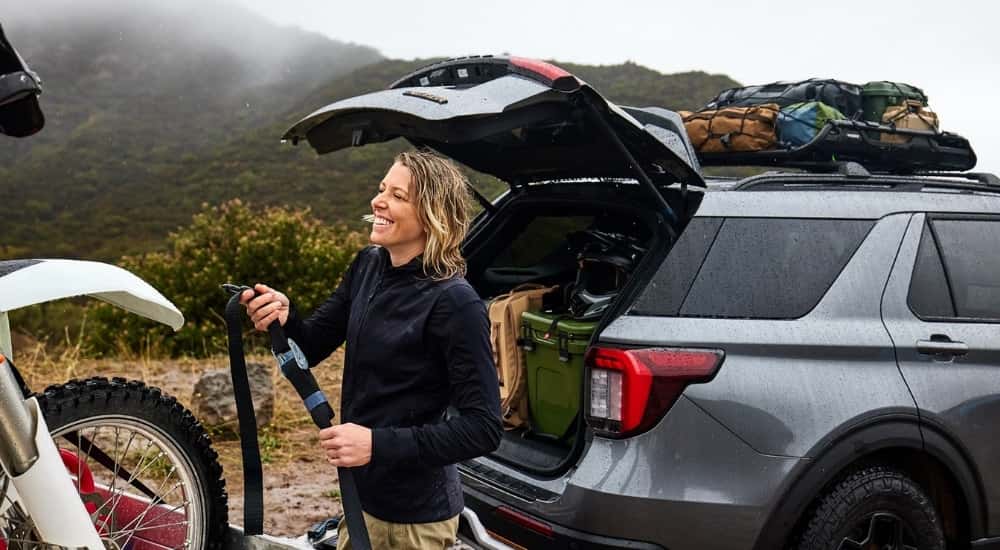 A person inflating a bike tire out of the trunk of their silver 2026 Ford Explorer Tremor