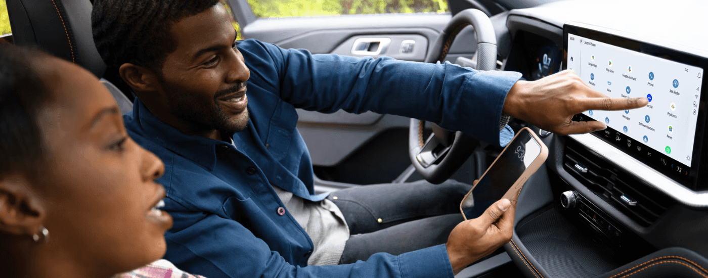 A person connecting their phone to the infotainment system in a 2026 Ford Explorer