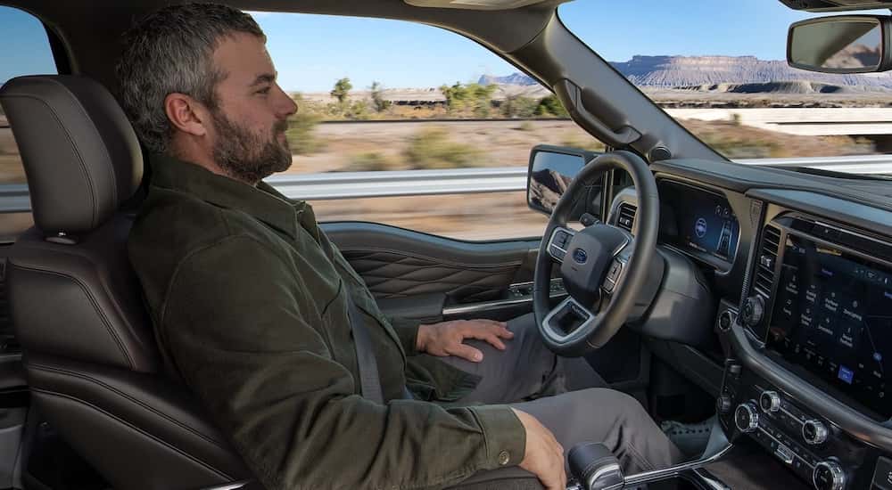 Person using BlueCruise inside of a 2025 Ford F-150.