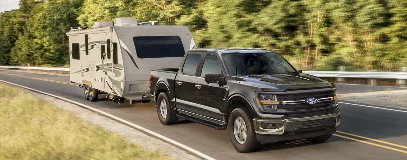 A black 2025 Ford F-150 for sale near Nassau towing trailer
