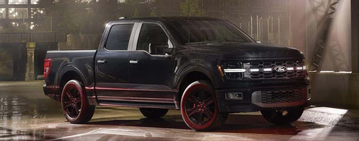 A black 2025 Ford F-150 parked indoors.