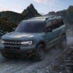 A blue used 2024 Ford Bronco Sport off-roading from a car dealer near Amsterdam