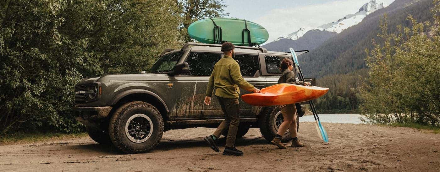 Grey 2026 Ford Bronco parked off-road with kayaks