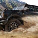 A black 2026 Ford Bronco off-roading in sand