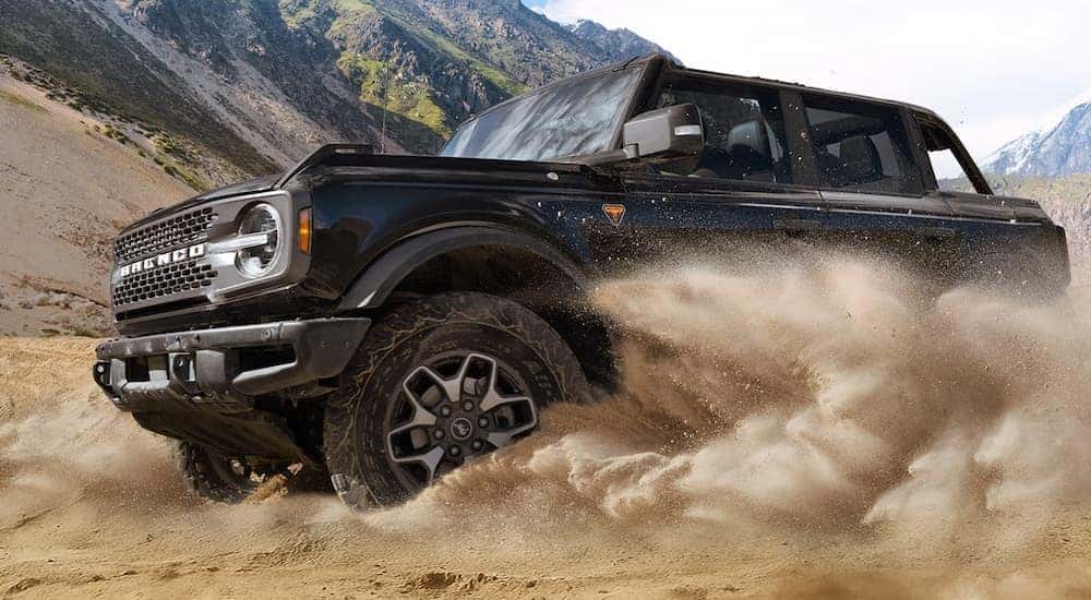 A black 2026 Ford Bronco off-roading in sand