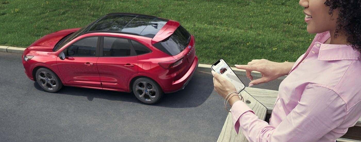 Red 2023 Ford Escape parked by a curb after visiting a used car dealer near Ballston Spa.