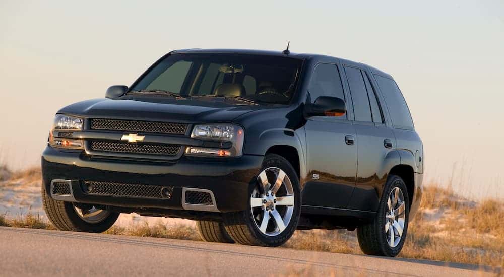 A black 2009 Chevy Trailblazer parked on a sunny day.
